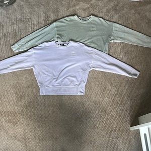 These are 2 nike thick long sleeve shirts. They are both in size women’s large.